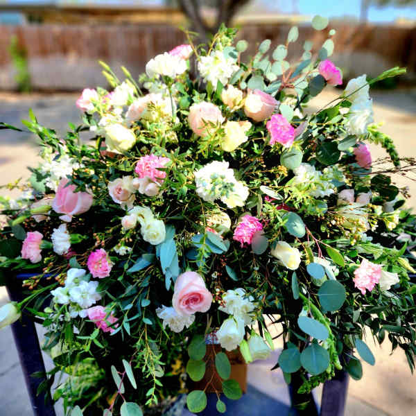 Large pink and white floral arrangement with roses and carnations