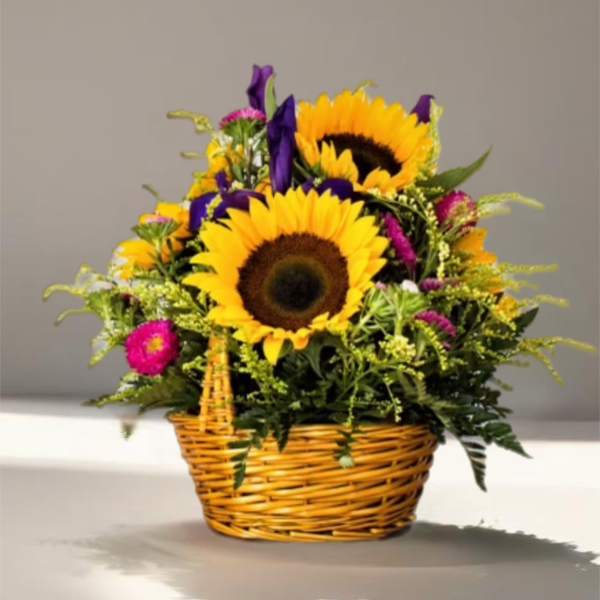 Basket arrangement with sunflowers and purple flowers