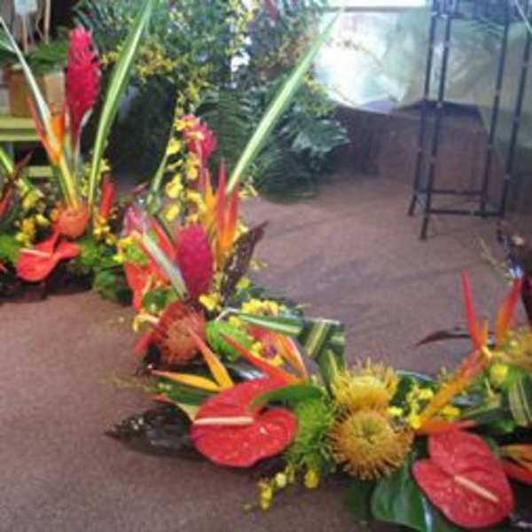 Tropical floral arrangements with red anthuriums and orange bird-of-paradise flowers