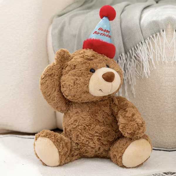 Teddy bear wearing a happy birthday party hat