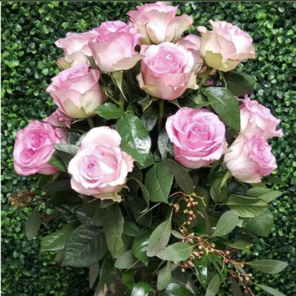 Pink roses arranged in a clear glass vase