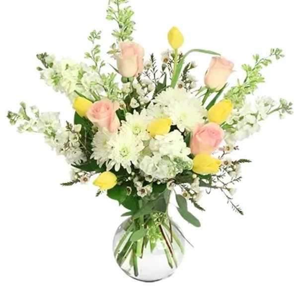 Pink roses and yellow tulips in a clear glass vase
