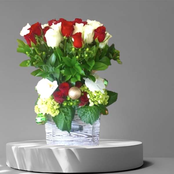 Red and white roses arranged in a square container