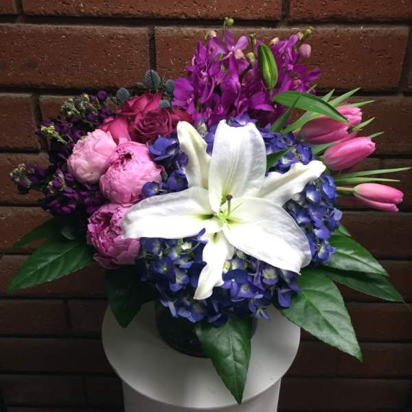 Bouquet of white lilies, pink roses, purple hydrangeas, and pink tulips