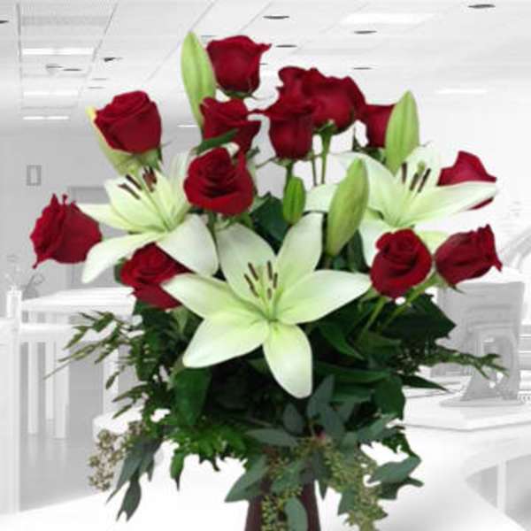 Red roses and white lilies in a tall vase