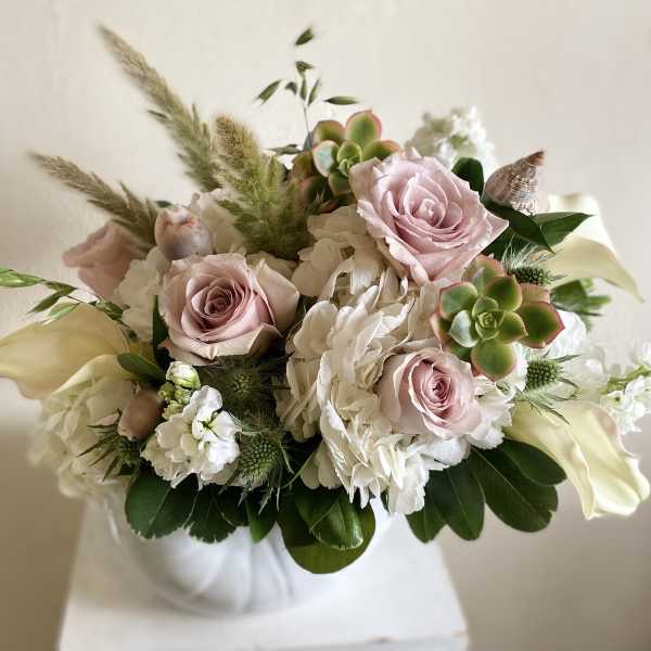 Bouquet of pale pink roses, white flowers, and succulents