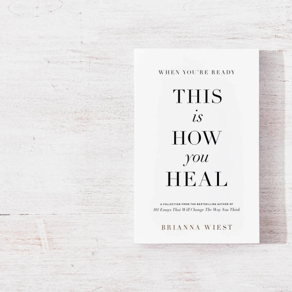 A book titled "This Is How You Heal" on a white wooden surface