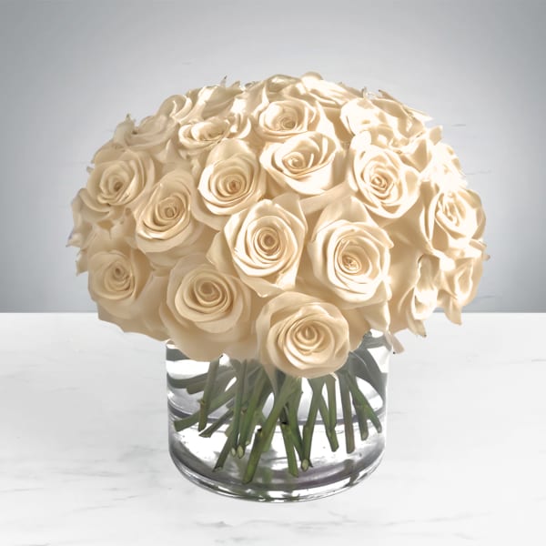 Cream rose bouquet in a clear glass vase