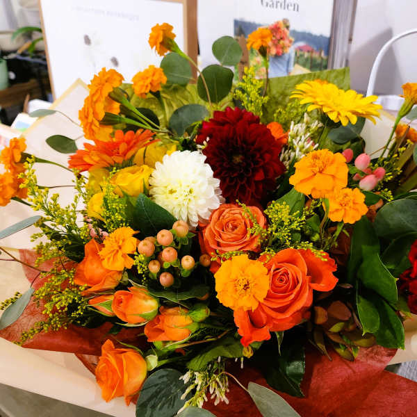 Mixed bouquet of orange, yellow, white, and red flowers