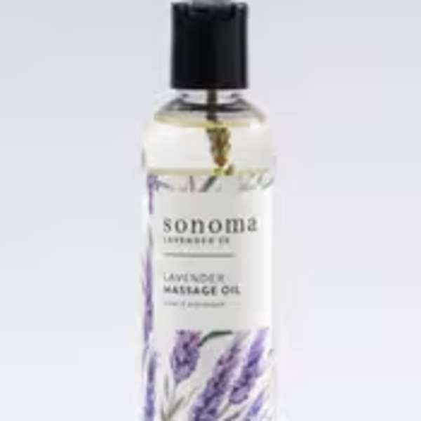 Bottle of lavender massage oil with illustrated purple lavender sprigs and a black cap