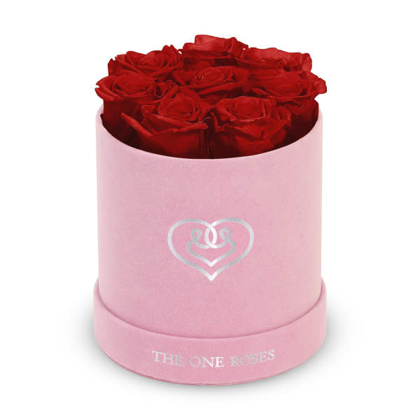 Red roses arranged in a pink round box with a heart logo