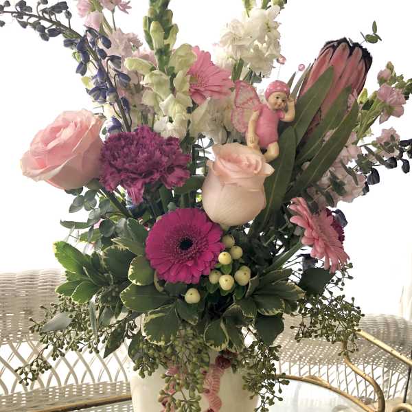 Tall mixed bouquet in a white vase with pink and white flowers