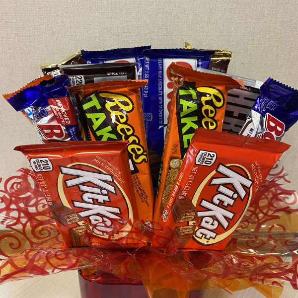 Chocolate candy bouquet in a red container with orange ribbon