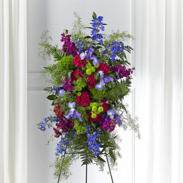 Tall standing floral spray with blue, purple, and pink flowers