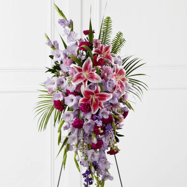Tall standing spray of pink lilies and lavender flowers