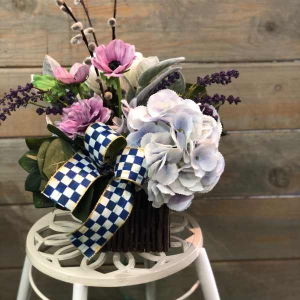 Bouquet of pink and white flowers with a blue checkered ribbon