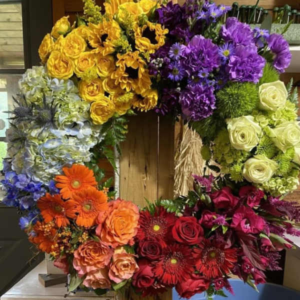 Colorful floral wreath with roses, gerbera daisies, and hydrangeas