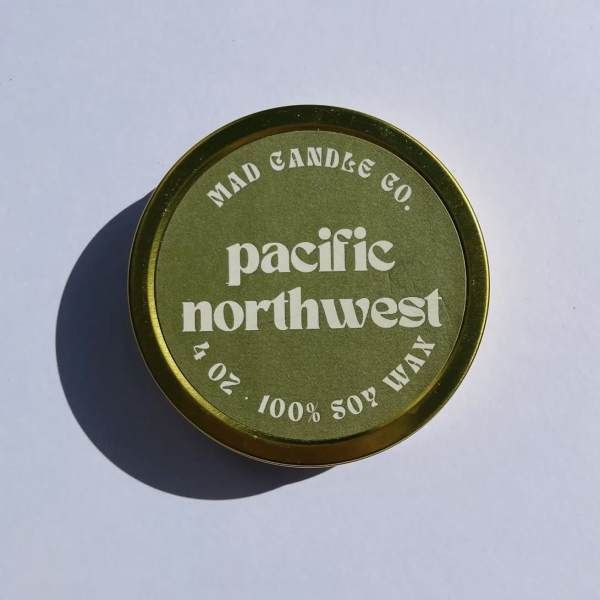 Round green candle tin with Pacific Northwest branding