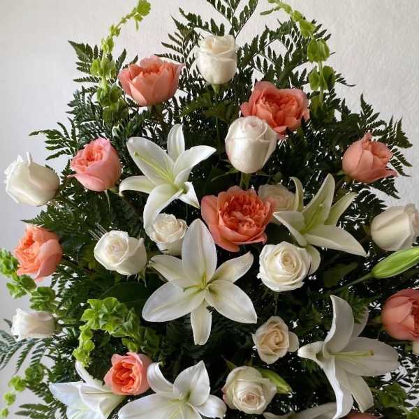 Standing floral spray with white lilies and peach roses