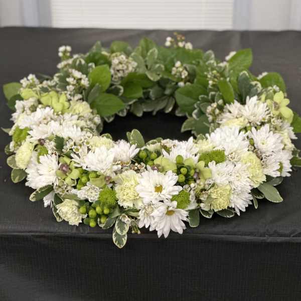 White and green floral wreath with daisies and carnations