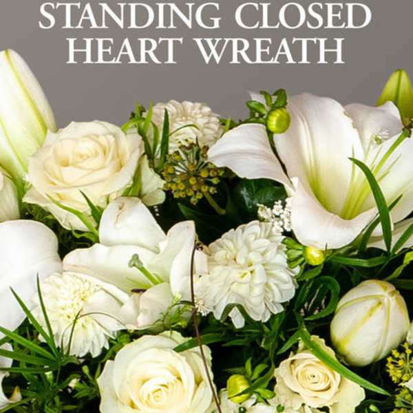 White flowers arranged in a standing heart wreath