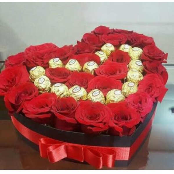 Heart-shaped box of red roses with gold-wrapped chocolates