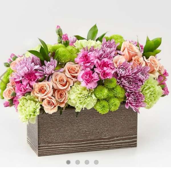 Mixed pink and green floral arrangement in a rectangular wooden box