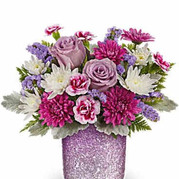 Bouquet of pink and lavender flowers in a glittery vase