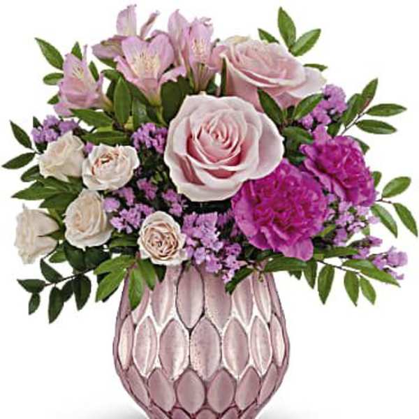 Pink and white flower arrangement in a pink textured vase