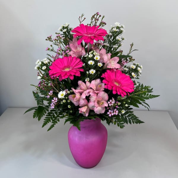 Pink and white mixed bouquet in a magenta vase