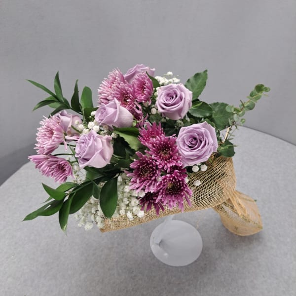 Lavender roses and purple chrysanthemums in burlap wrap