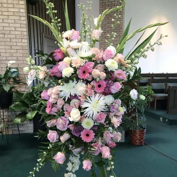 Large pink and white floral standing spray on an easel