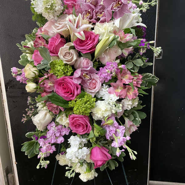 Large pink and white floral standing spray on an easel