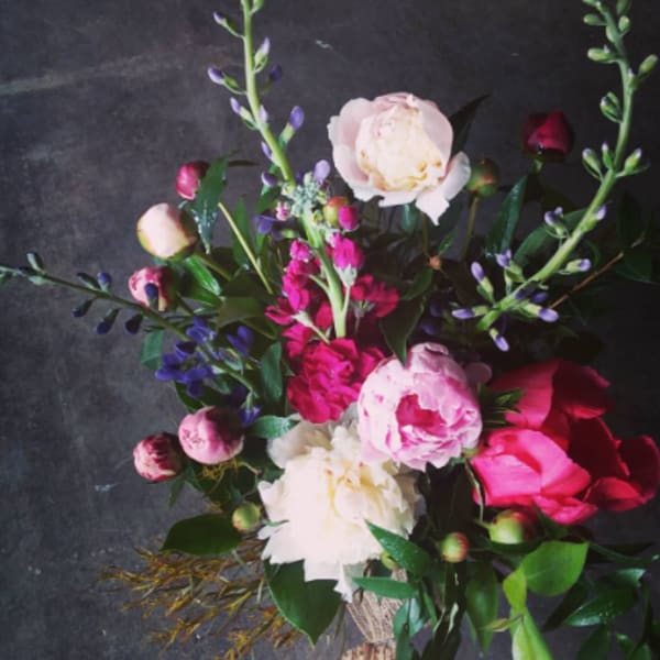 Bouquet of pink and white peonies with purple accents