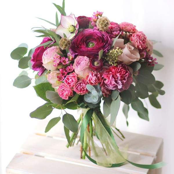 Bouquet of pink and magenta flowers with eucalyptus greenery