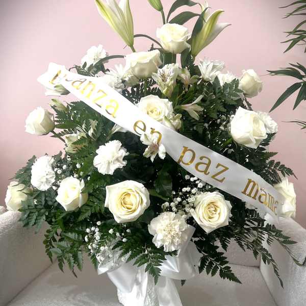 White rose and lily arrangement with a condolence ribbon