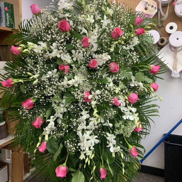 Large standing spray of pink roses and white orchids