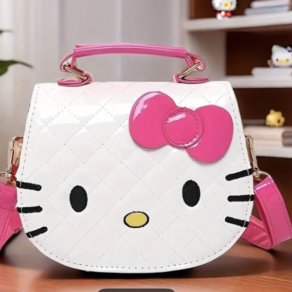 Hello Kitty-shaped white and pink handbag on a table