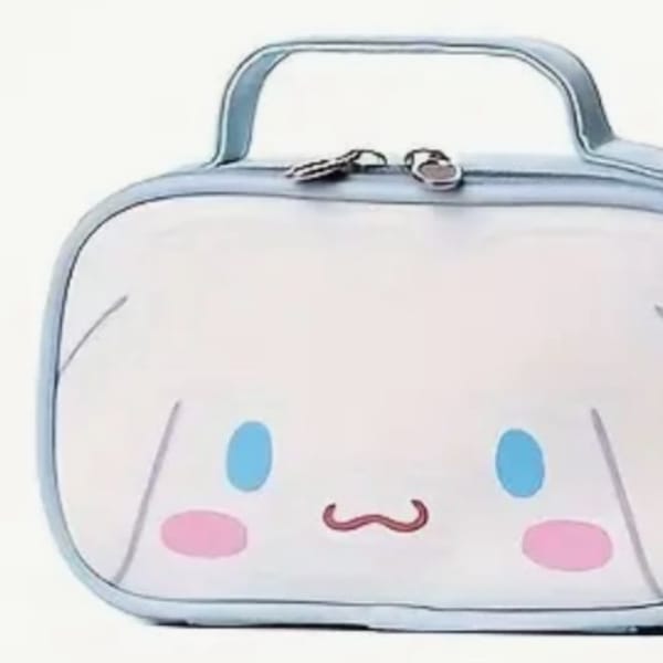 Cute white zippered pouch with a cartoon face and blue handle