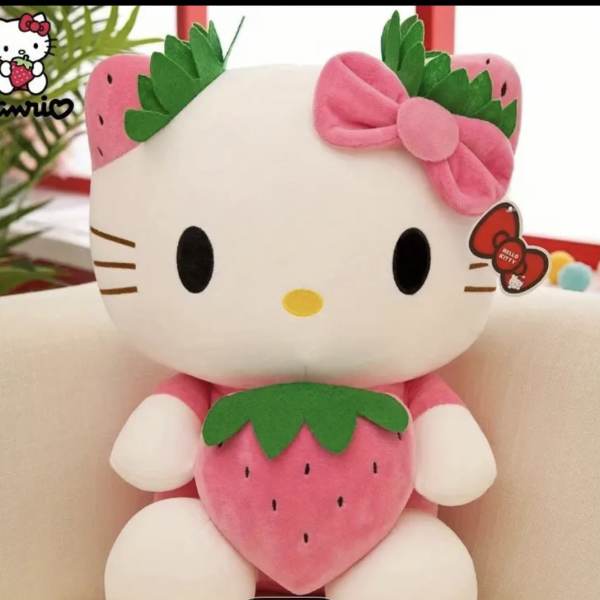 Hello Kitty plush toy holding a strawberry, with a pink bow