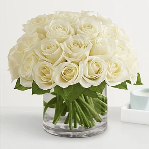 White rose bouquet in a clear glass vase