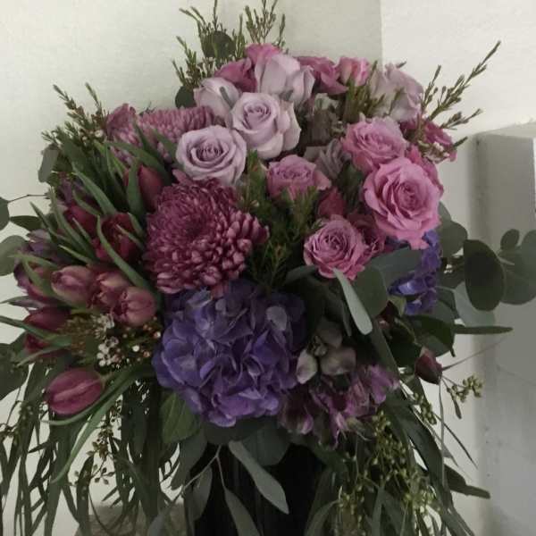Pink and purple mixed bouquet in a black vase