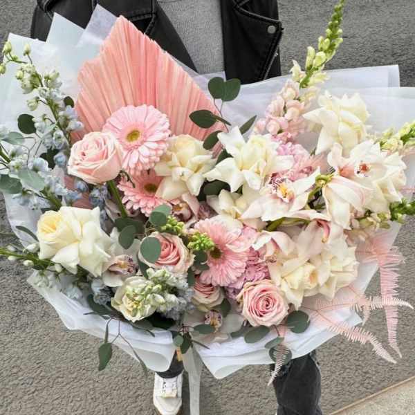 Large pastel bouquet with pink and white flowers wrapped in white paper