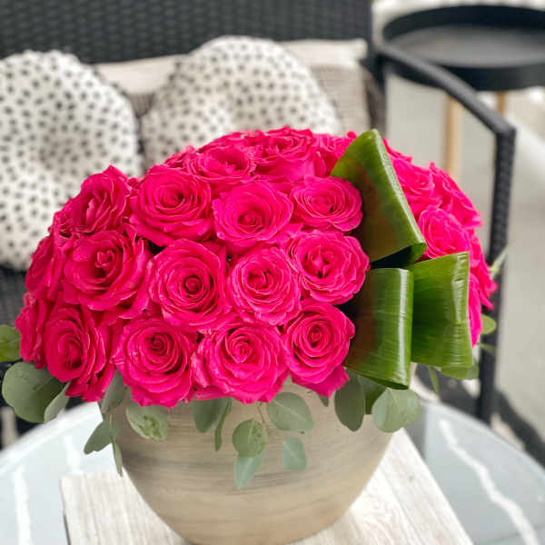 Hot pink rose bouquet in a round beige vase