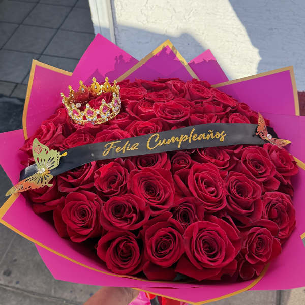 Large bouquet of red roses with a small crown and birthday ribbon