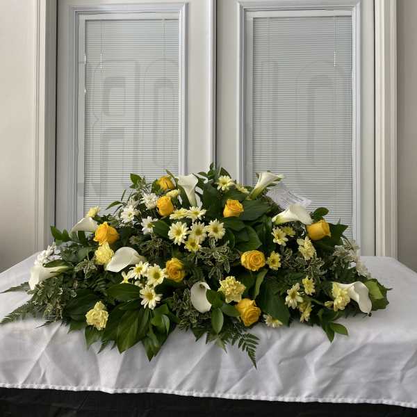 Large white and yellow floral spray with calla lilies and roses