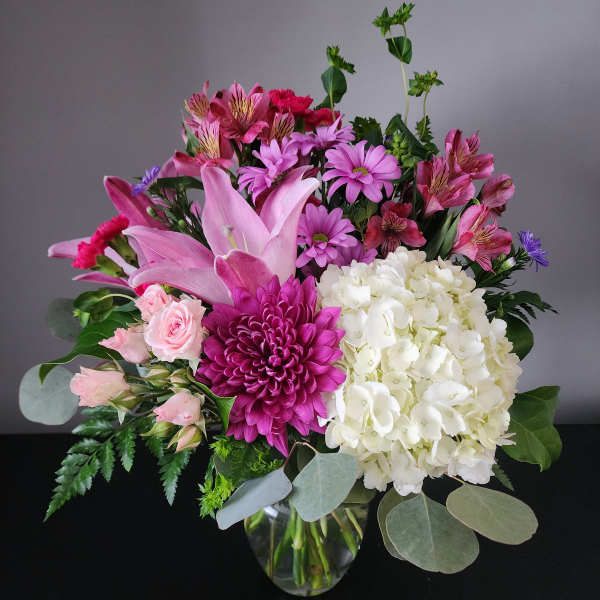 Pink and white mixed bouquet in a clear glass vase