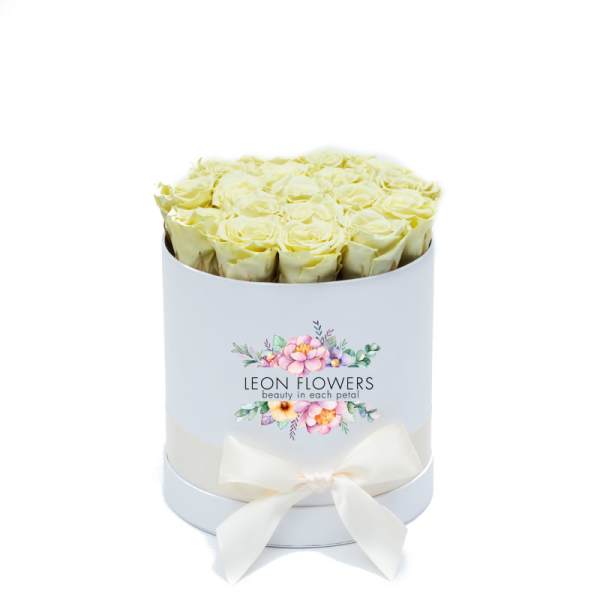 Box of pale yellow roses with a white ribbon