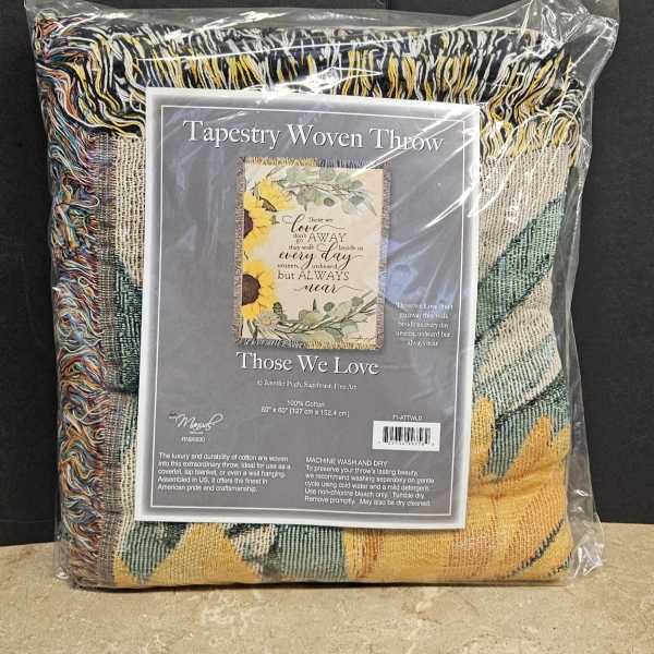 Packaged woven throw blanket with a sunflower and memorial message