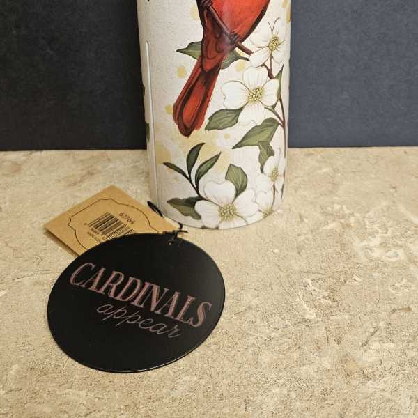 Tall cylindrical vase with a red cardinal and white flowers